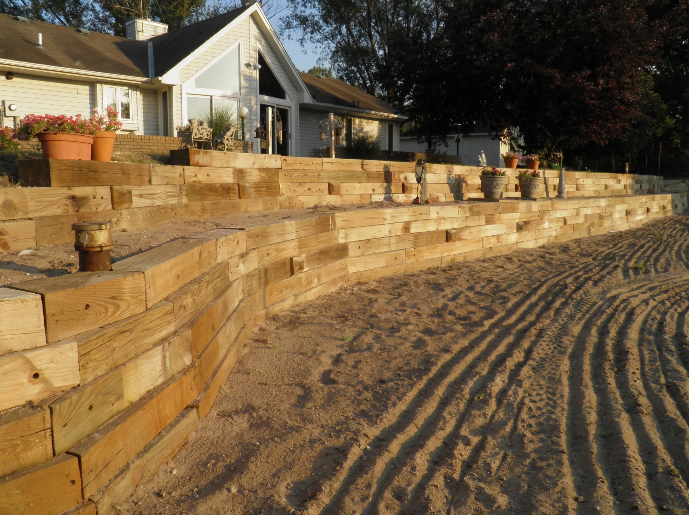 Timber retaining wall with railroad ties in residential yard